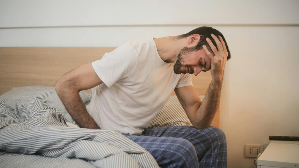 Man struggling in bed with low back pain