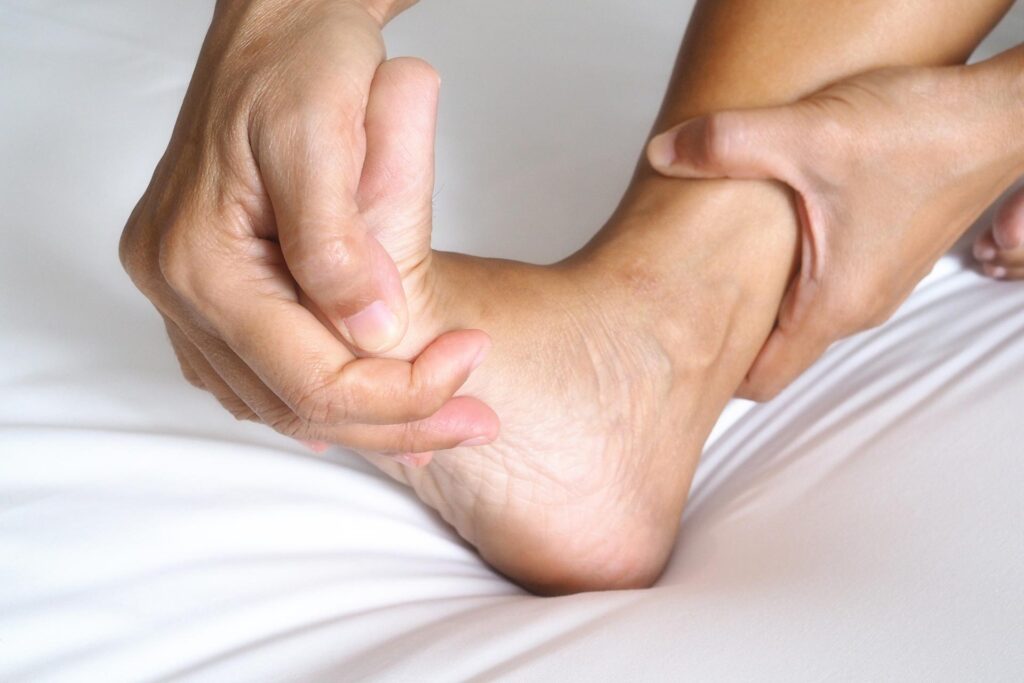 Person holding foot as the feel the pain of Plantar fasciitis