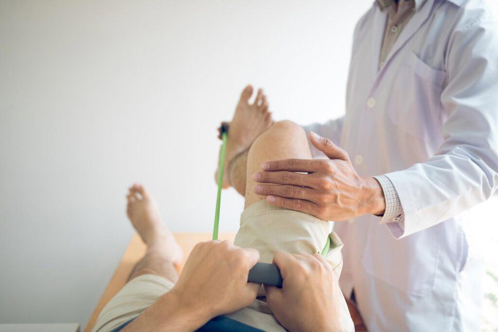 Chiropractor doing some Arthritis tests on a patient using a exercise bands