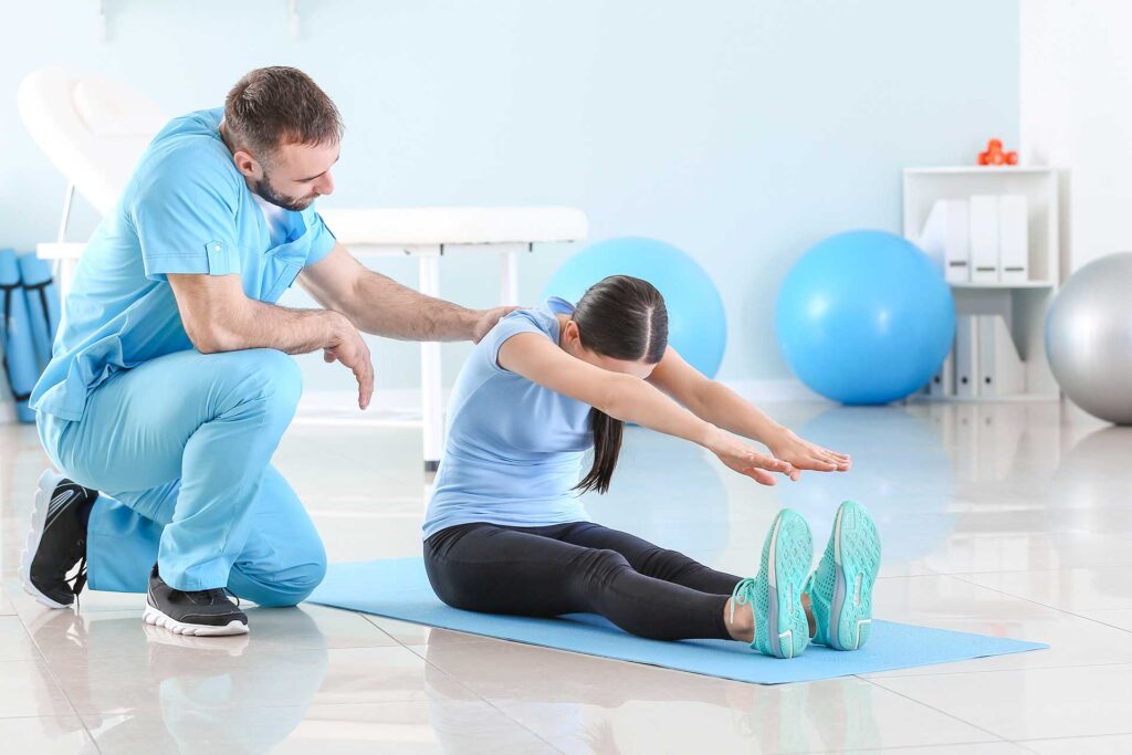 Chiropractor doing some stretches with patient