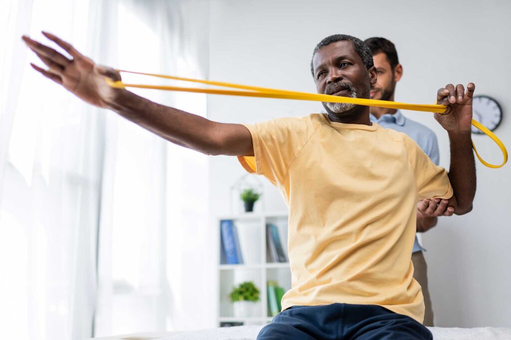 Chiropractor doing some stretches with an older patient