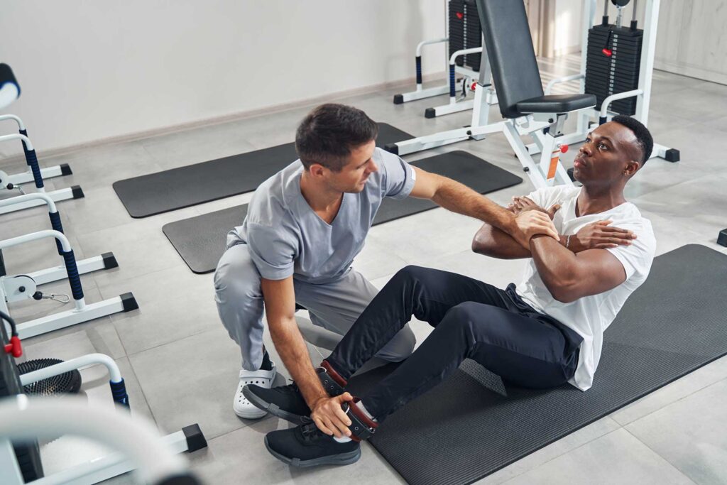 Chiropractor doing some stretches with patient, sports rehabilitation